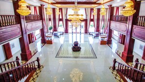 A grand lobby with a central chandelier, wooden railings, and a polished floor. - 36 Manor International Sport Hotel (Vientiane)