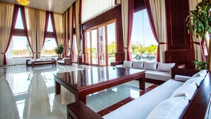 A spacious lobby with a large seating area, a polished marble floor, and large windows with curtains. - 36 Manor International Sport Hotel (Vientiane)