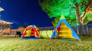 Two colorful tents set up on a grassy area at night. - Pine Trees Apartment (Preveza)