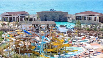 A water park with multiple slides and pools, a large rock formation labeled 'WATER WORLD,' and a beach area with sun loungers.