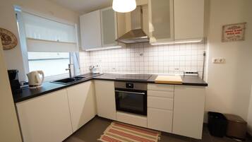 Apartment | Private kitchen | Fridge, oven, stovetop, dishwasher