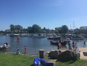 A marina with boats, a grassy area, and a clear sky. - Quay Corner Christchurch Dorset (Christchurch)