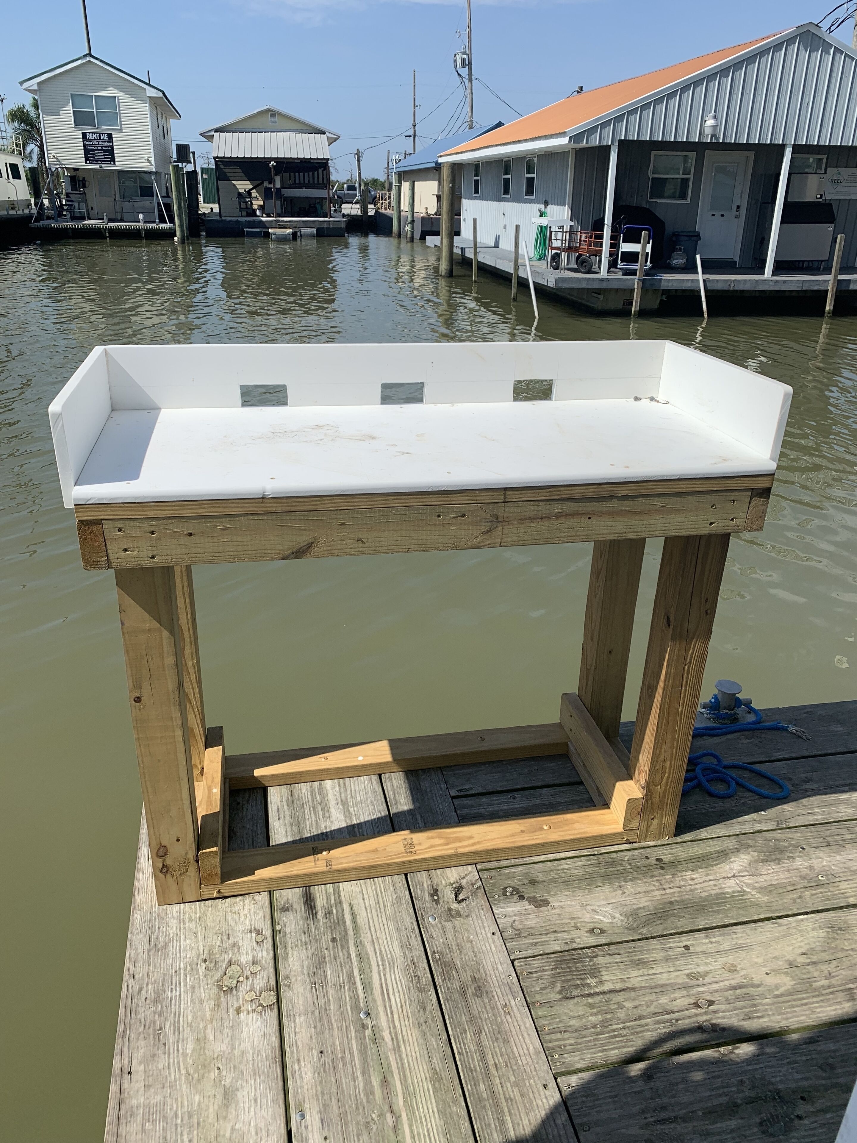 Une jetée en bois avec une table blanche.