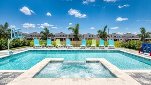 A swimming pool with lounge chairs, a hot tub, and a basketball hoop. - Energetic Bright Villa With Theater at Encore (Kissimmee)
