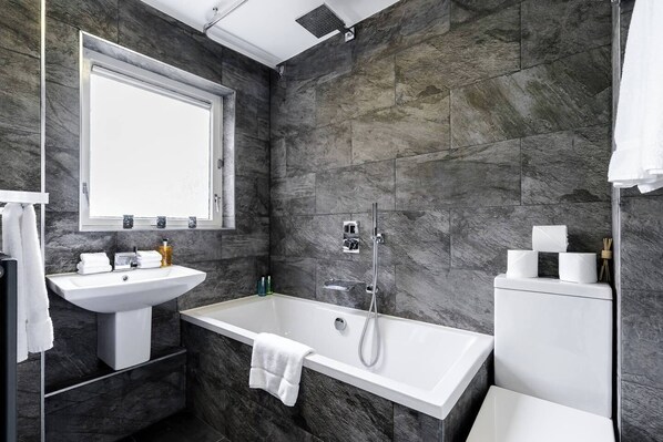 Bathtub, hair dryer, soap, shampoo