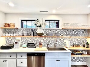 Enjoy cooking in this well-equipped kitchen with a central island, double sink, and ample counter space.