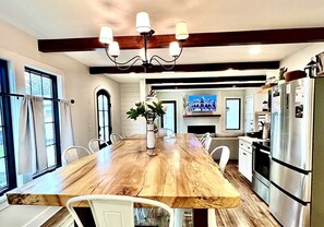 Enjoy meals together at the large dining table surrounded by comfortable chairs.