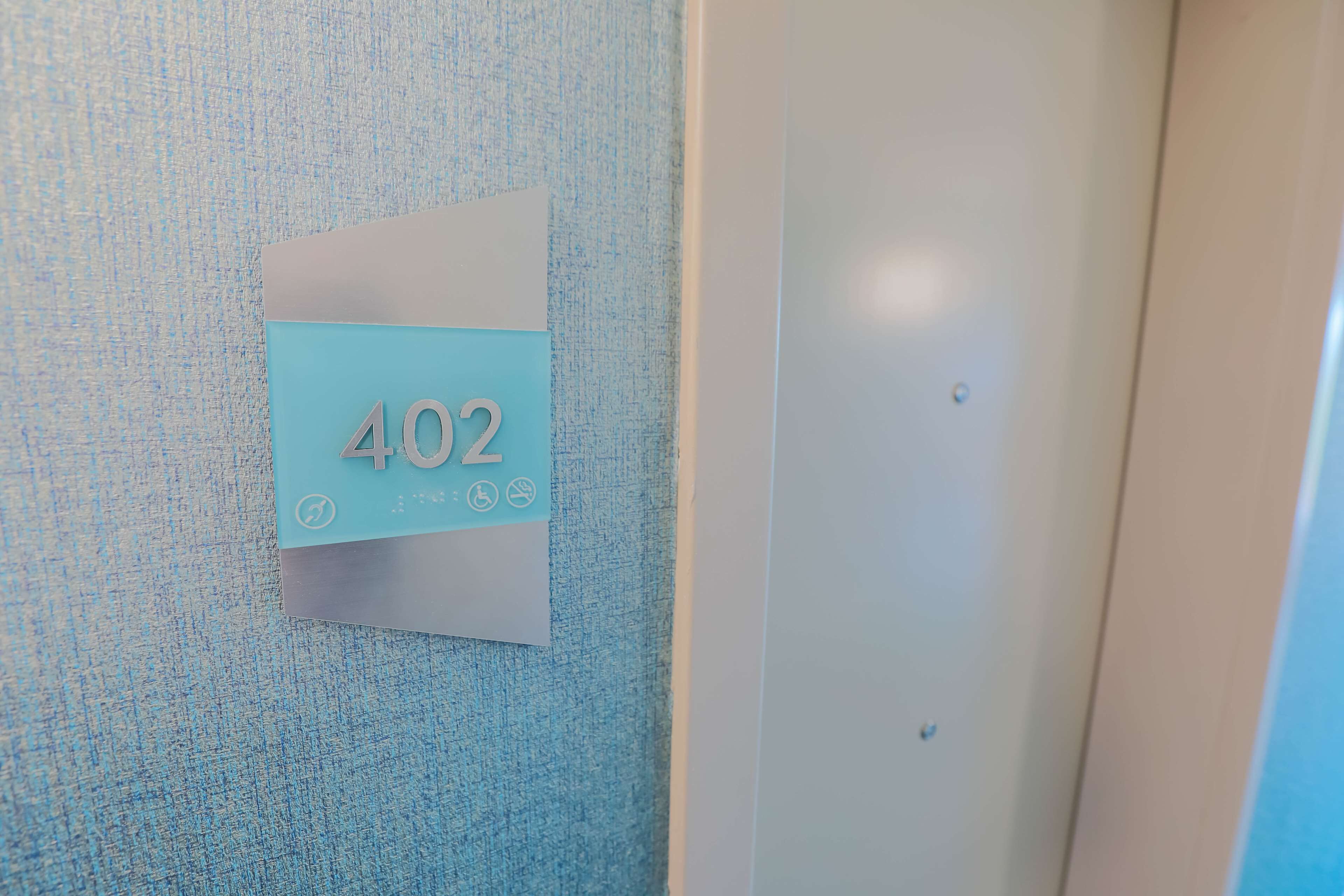 A wall-mounted sign with the number 402, indicating a room or location.