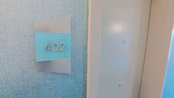 A wall-mounted sign with the number 402, indicating a room or location.