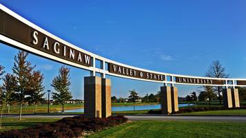 A sign for Sagina Valley State University with a clear view of the surrounding landscape.