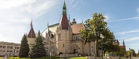 A historic building with a prominent tower and a large entrance.