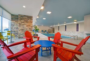 Una piscina techada, sillones reclinables de piscina