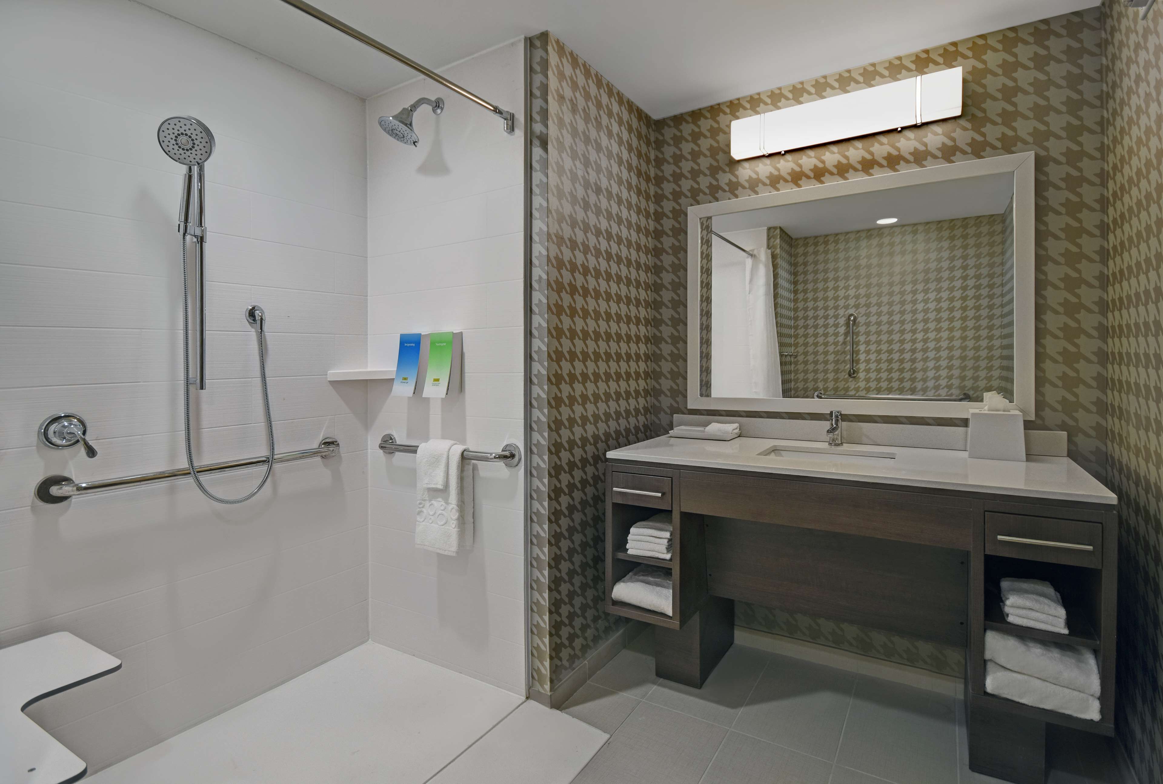 A modern bathroom with a shower, toilet, and vanity.