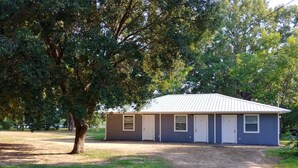A single-story building with a metal roof, two doors, and a small window.