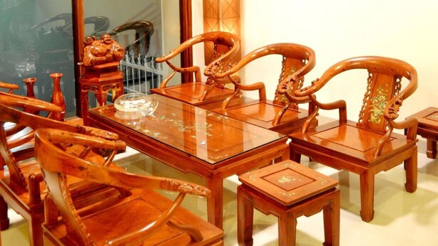 A traditional wooden dining table with matching chairs and a small side table. - White Lion Hotel Nha Trang (Nha Trang)