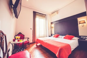 A hotel room with a bed, a chair, a table with breakfast, a TV, and a window with curtains. - Hostal Sol Los Angeles (Madrid)