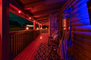 A wooden deck with a patterned floor, a bench, and a sign that reads "RELAX AND LUN WIND."
