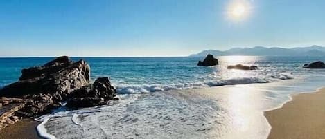 On the beach, sun loungers, beach towels