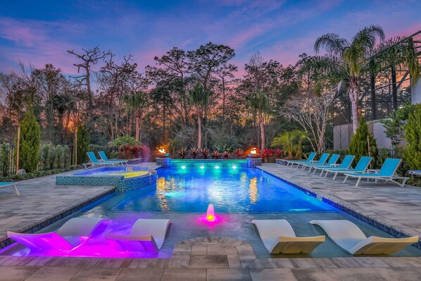 A heated pool, pool loungers - Great Escape Manor | Custom Built Home with Themed Kids Bedrooms, Game Room, and Theater Room (Kissimmee)