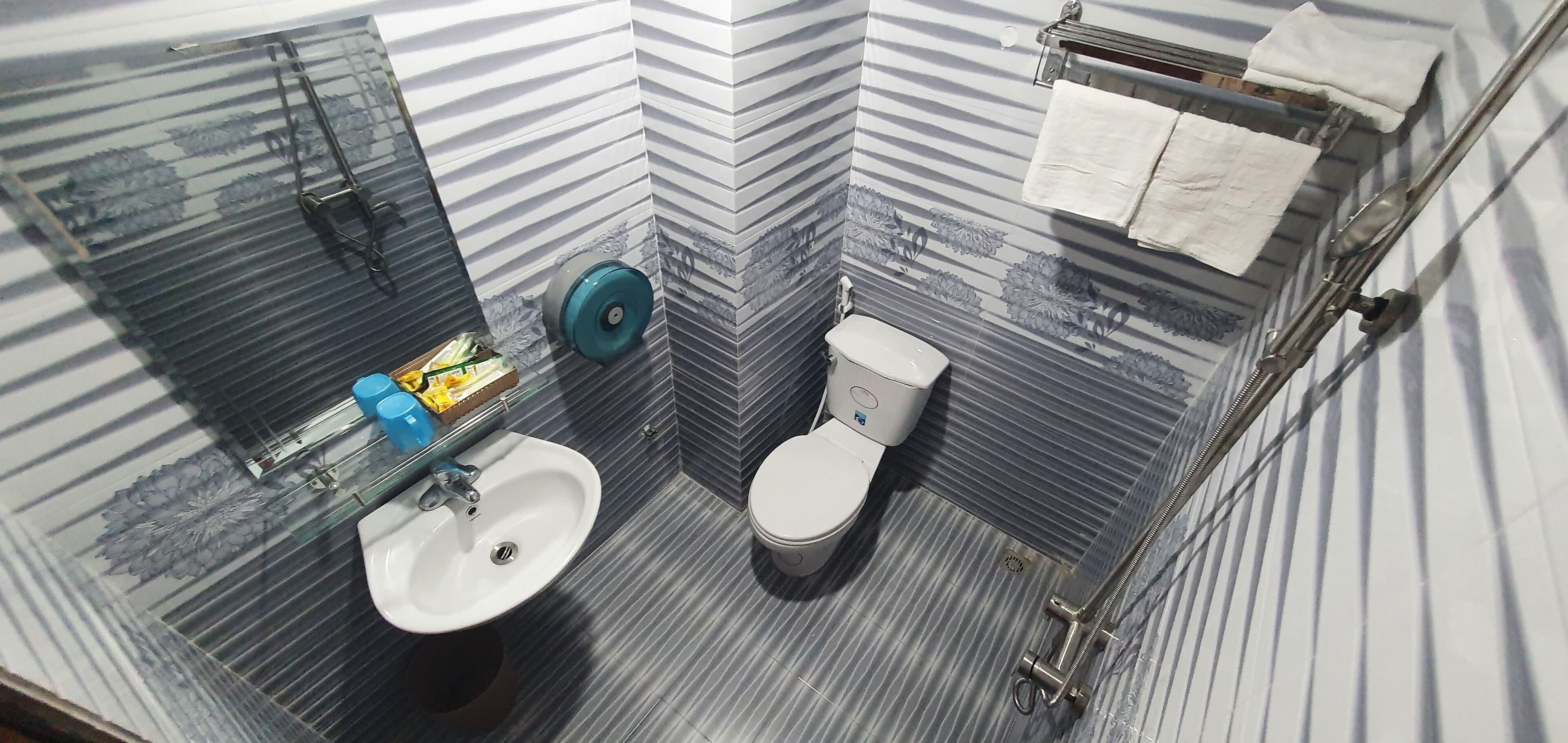 A bathroom with a sink, toilet, and shower area.