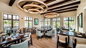 Enjoy group or dining in this spacious dining area with round tables and individual chairs.