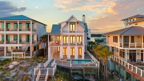 A beachfront property with multiple buildings, a swimming pool, and a beach access deck. - Stunning Retreat w/Gulf views, heated pool, beach access, and bikes. Sleeps 12! (Seagrove Beach)