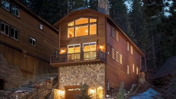 A two-story log cabin with a stone facade, a balcony, and a staircase leading to the entrance. - Bear Mtn Chalet |Walk 2 Zoo, Bear Mtn & Golf+Games (Big Bear Lake)