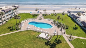 A resort with a swimming pool, beach access, and palm trees. - ✨Direct Ocean - Chateau by the Sea 13C✨ (New Smyrna Beach)