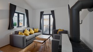 A modern living room with a sofa, coffee table, and a fireplace. - 46142 Montan 14 OG (St. Gallenkirch)