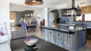 A modern kitchen with a central island, stainless steel appliances, and a large pendant light. - Villa Kallisto with Infinity Pool & Stunning Sea View in Perigiali, Lefkada!!! (Perigiali)