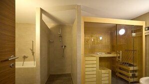 A modern bathroom with a glass-enclosed shower, a bathtub, and a wooden vanity.
