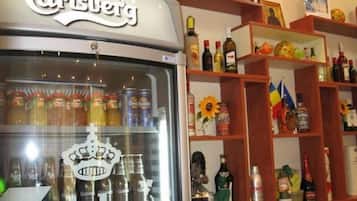 A store with a variety of beverages and alcohol on display, including a refrigerated section with cans and bottles.