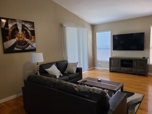 Relax in this stylish living room with a comfortable sofa, coffee table, and flat-screen TV.