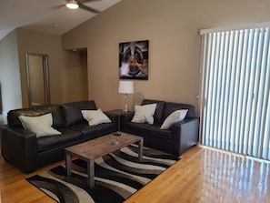 Relax in this stylish living room with a comfortable sofa, coffee table, and abstract art.
