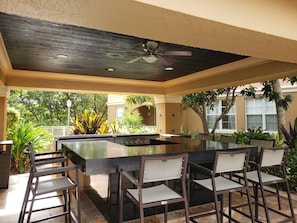Relax in this serene outdoor space with a grill and comfortable seating.