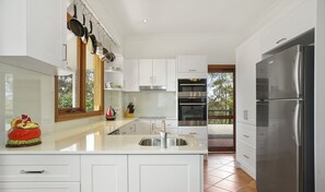 Enjoy cooking in this well-lit kitchen with a spacious island and sink.
