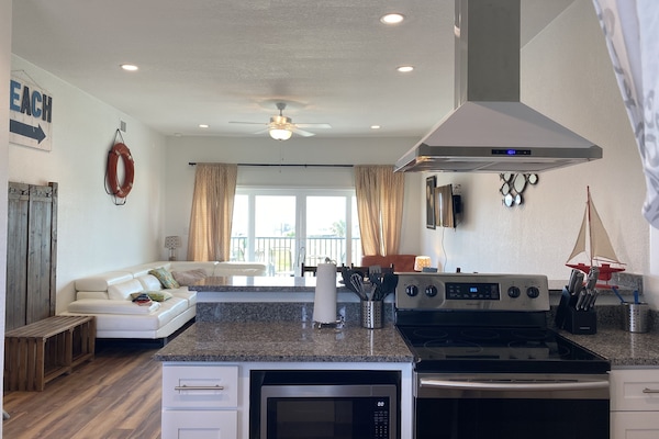 Beautiful beachfront condo with 14 foot slider to private patio facing the beach