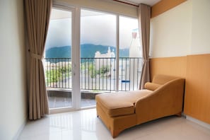 Chambre supérieure, 1 grand lit, vue sur la montagne | Aire de séjour | Téléviseur à écran plat de 43 po avec télévision par cùble, téléviseur