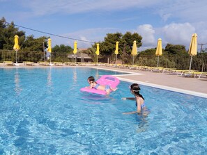 Seasonal outdoor pool, open 9:00 AM to 7:00 PM, pool umbrellas