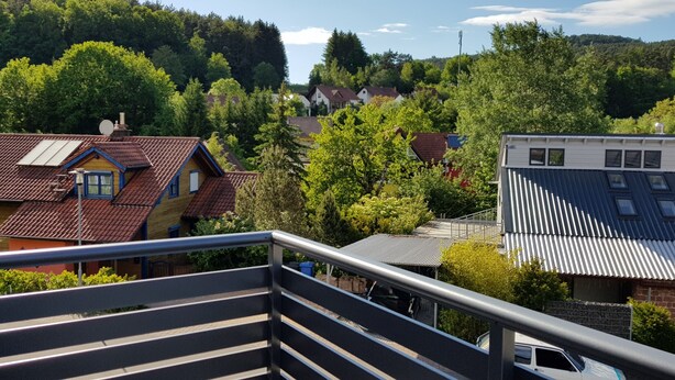 A residential area with houses, a staircase, and a view of a forested hill. - Vacation apartment time out! In the middle of the Palatinate Forest. (Erfweiler)