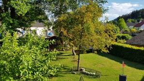 A residential area with houses, a well-maintained lawn, and a tree. - Vacation apartment time out! In the middle of the Palatinate Forest. (Erfweiler)
