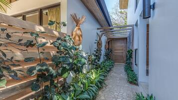 Stroll through this serene outdoor corridor, lined with lush greenery and decorative accents.