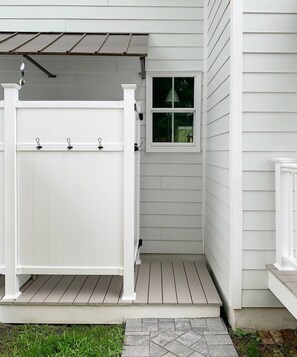 A white wooden house with a white fence, a small window, and a stone pathway leading to the entrance. - Doublemint Townhouse, Walk to Beach & Downtown (Cape Charles)