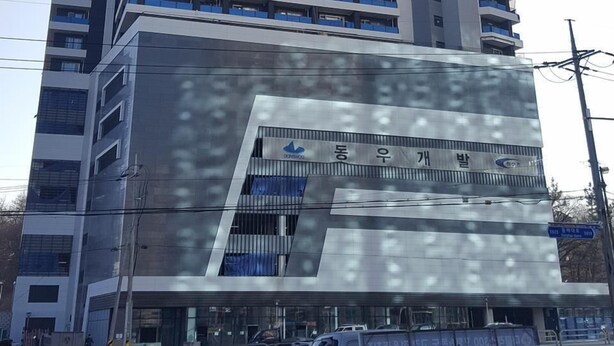 A high-rise building with multiple floors, large windows, and a modern architectural design. - Sokcho Blue Terra Pension (Sokcho)