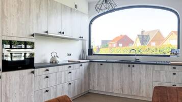 Fridge, stovetop, dishwasher, coffee/tea maker