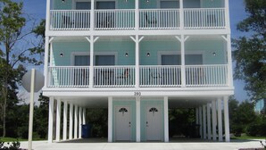 A two-story building with a balcony on each floor, numbered 280, and a covered entrance with two doors. - New Construction, Warm Coastal Feel, Home Away From Home
Covered Parking (Myrtle Beach)