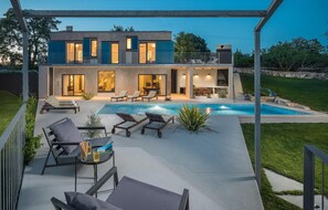 A modern two-story house with a swimming pool, outdoor seating, and a covered patio area. - Beautiful home in Barban (Barban)