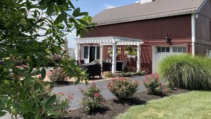 A red barn with a white porch and a covered patio area. - 2A2J Barn pool Getaway 9 miles to WEC (Wilmington)