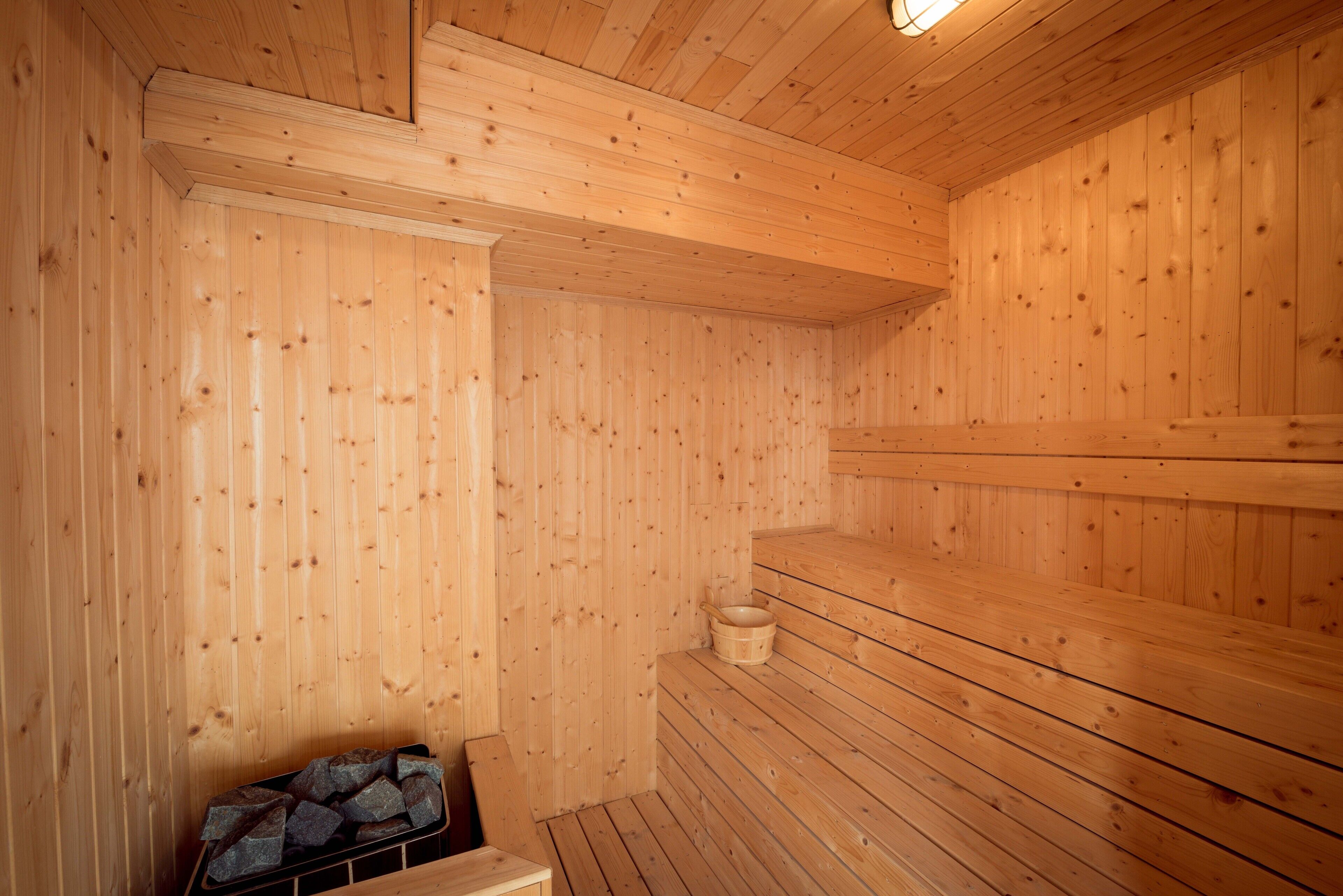 Una sauna de madera con bancos y un banco de madera.