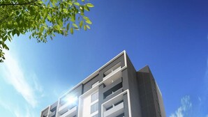 A modern multi-story building with balconies, large windows, and a flat roof. - Omura Station Hotel Nagasaki Airport (Omura)